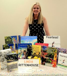 This is an author surrounded by children's books.