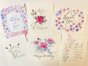 floral paper invites with cursive font and pink and red flowers