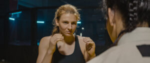 Two mixed martial arts female fighters in sports club. Training fight