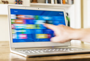 A person moving a finger across the touchscreen of an Acer S7 Ultrabook