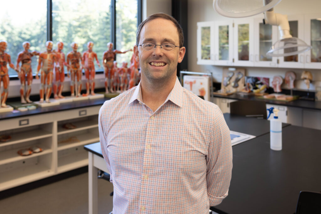 Professor Ben Wiggin standing in biology lab