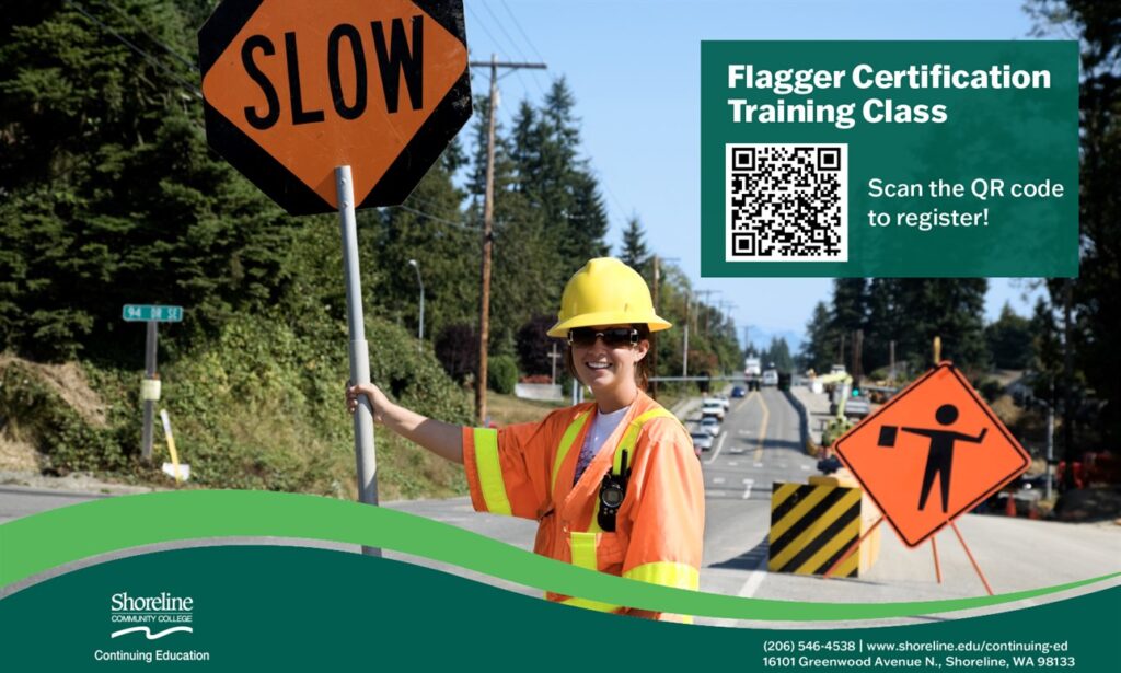 This is an image of a woman in a construction vest holding a sign.