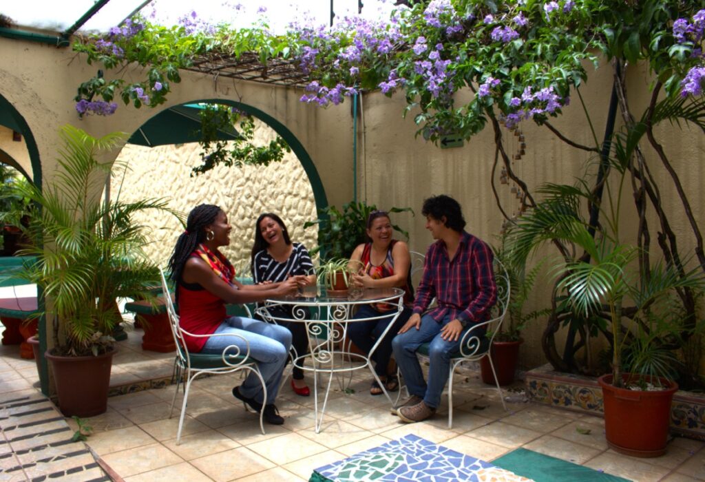 Students sitting at a table on an outdoor patio.