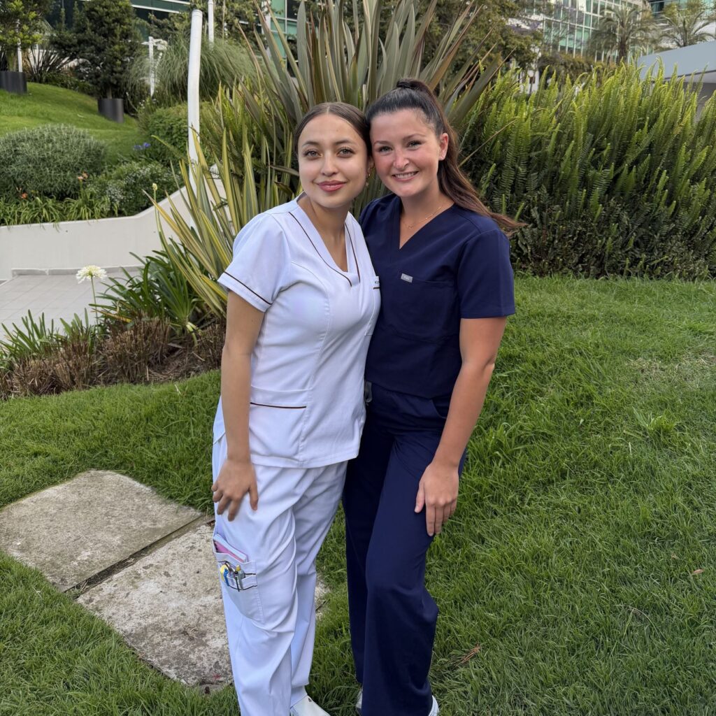 Photo of two nursing students posing outdoors. 