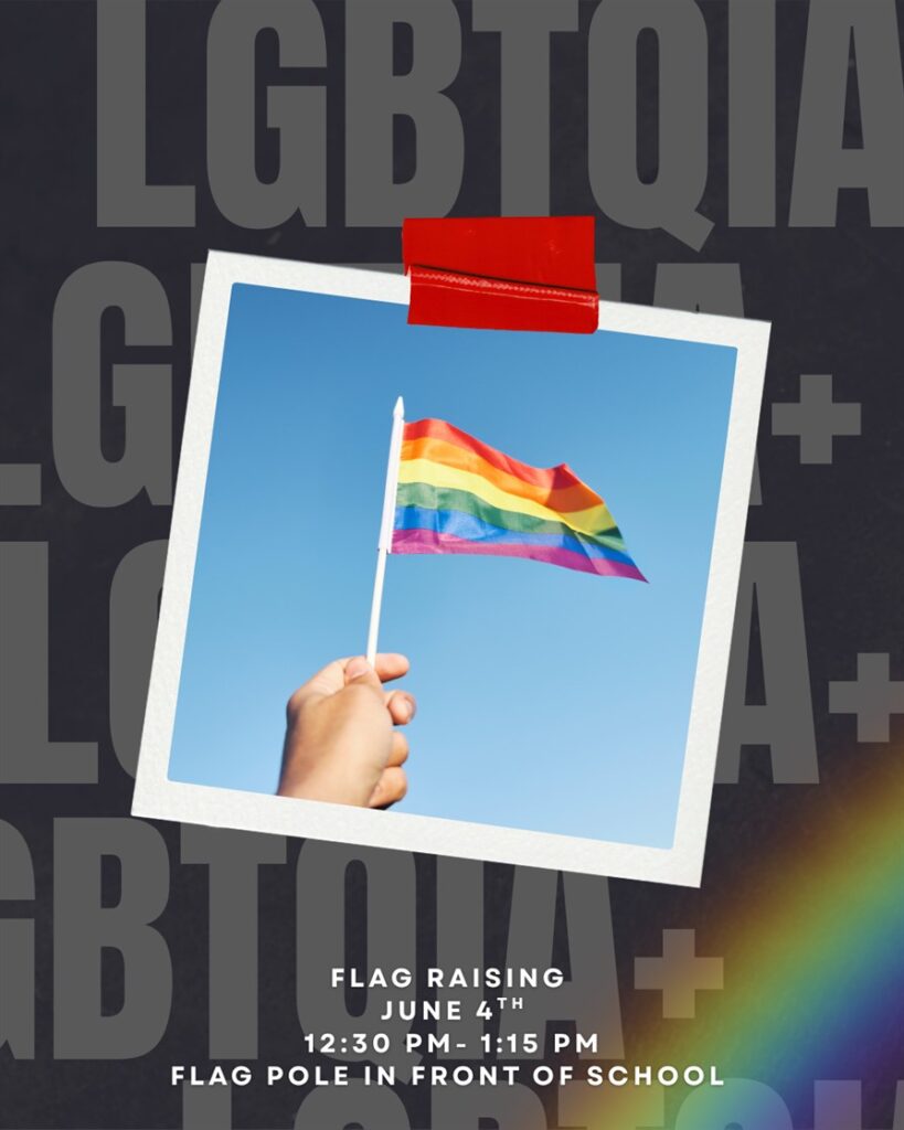A hand holding a pride flag. 
